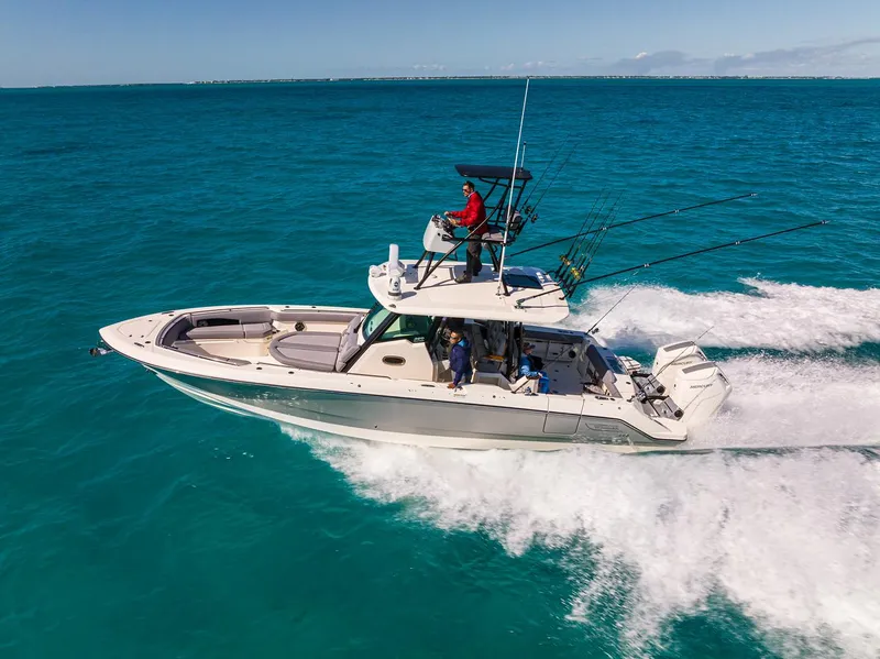 Slide: The Image of 2024 Boston Whaler 360 Outrage cruising on clear blue ocean waters. - 16