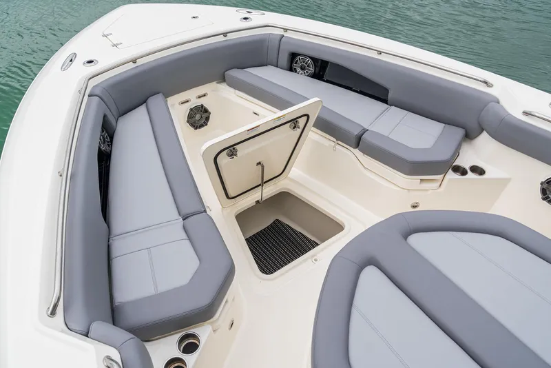 Slide: The Image of 2024 Boston Whaler 360 Outrage boat interior with gray seating and storage compartment. - 6