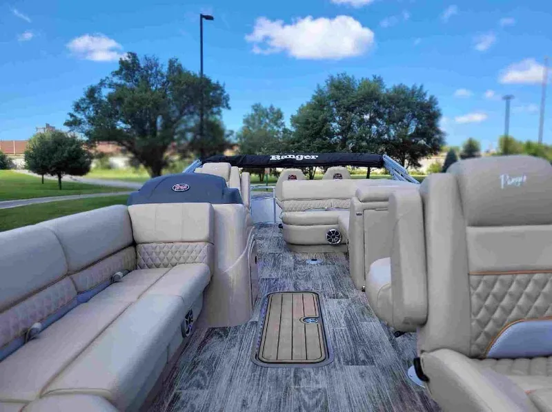 Slide: The Image of 2024 Ranger Reata 223FC boat interior with luxurious seating and wood flooring. - 3