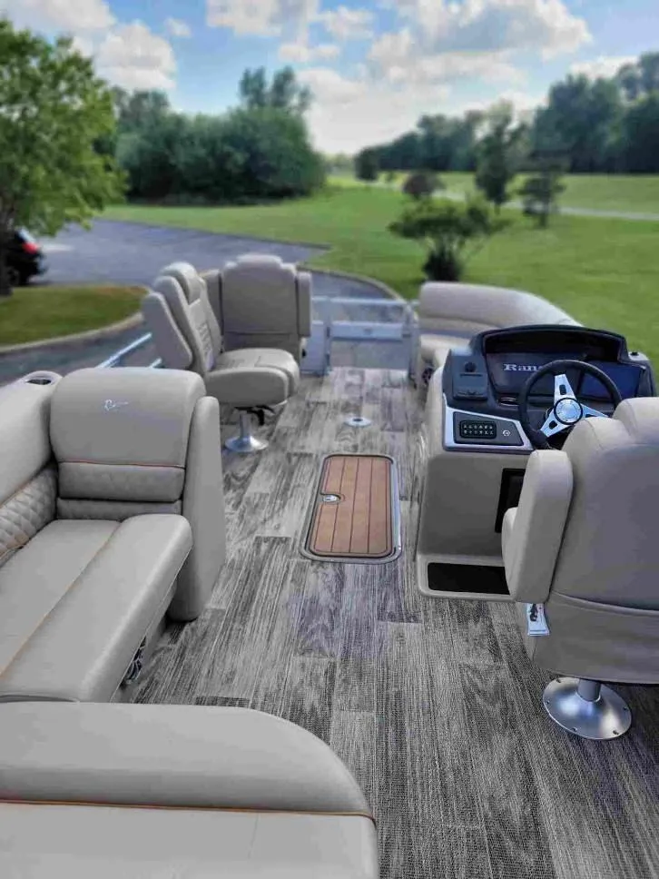 Slide: The Image of 2024 Ranger Reata 223FC pontoon boat interior with plush seating and modern controls. - 4