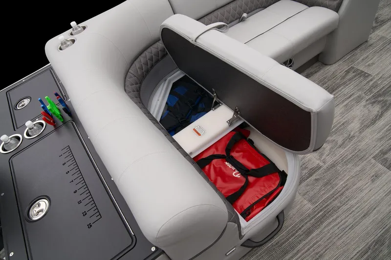 Slide: The Image of 2024 Ranger Reata 223FC boat with open storage compartment and safety gear. - 46
