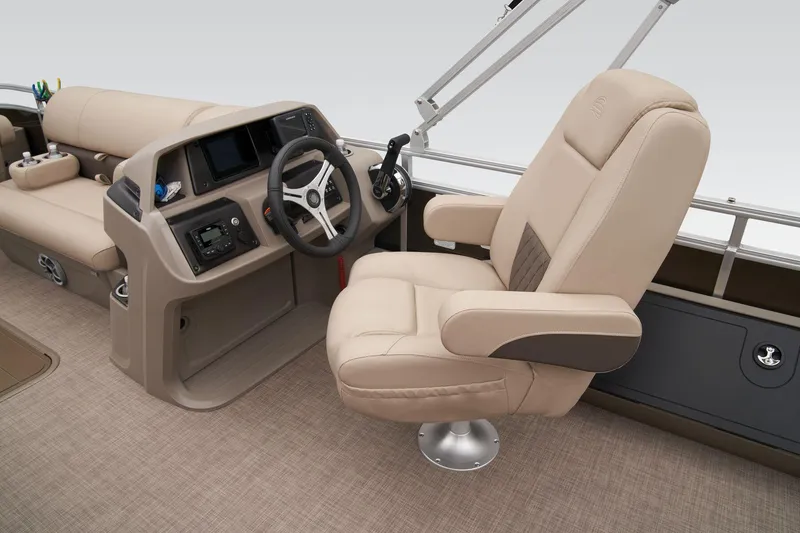 Slide: The Image of 2024 Sun Tracker Sportfish 24 XP3 helm with beige captain's chair and control console. - 30