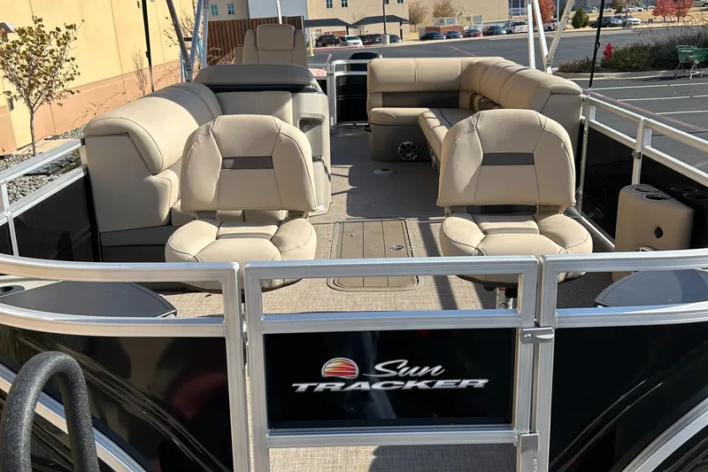Slide: The Image of 2024 Sun Tracker Sportfish 24 XP3 pontoon boat with beige seating. - 3