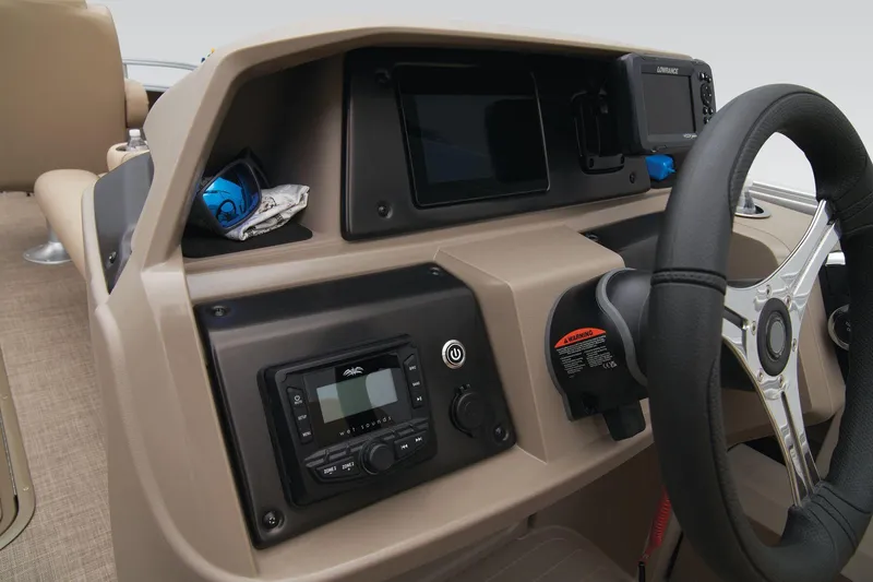 Slide: The Image of 2024 Sun Tracker Sportfish 24 XP3 dashboard with steering wheel and control panel. - 39