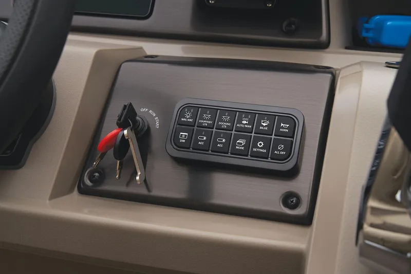 Slide: The Image of 2024 Sun Tracker Sportfish 24 XP3 control panel with ignition keys. - 41