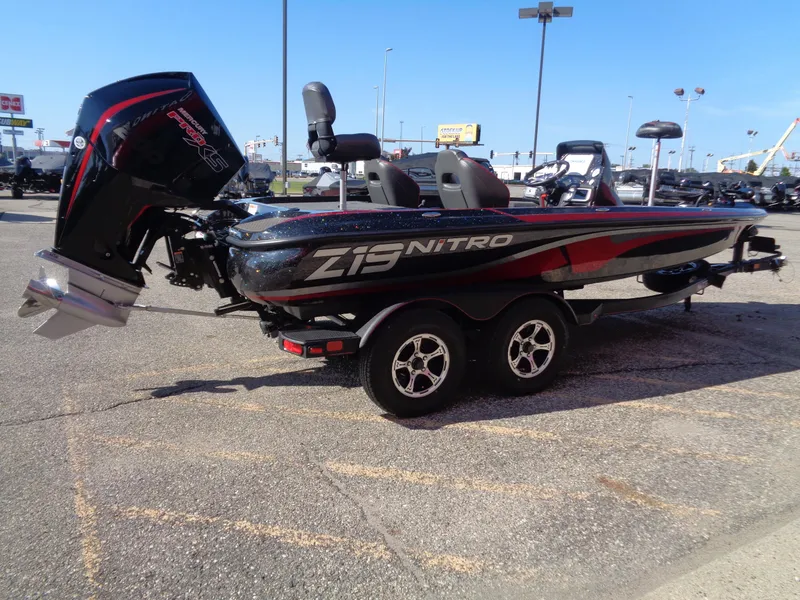 Slide: The Image of 2024 Nitro Z19 Pro bass boat with dual console and outboard motor. - 5