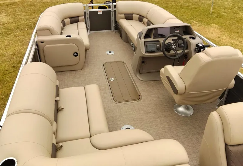 Slide: The Image of 2024 Sun Tracker Party Barge 22 RF XP3 interior with beige seating and modern helm. - 5