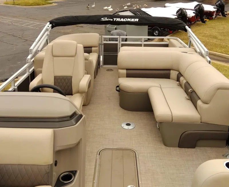 Slide: The Image of 2024 Sun Tracker Party Barge 22 RF XP3 interior with beige seating and helm. - 7