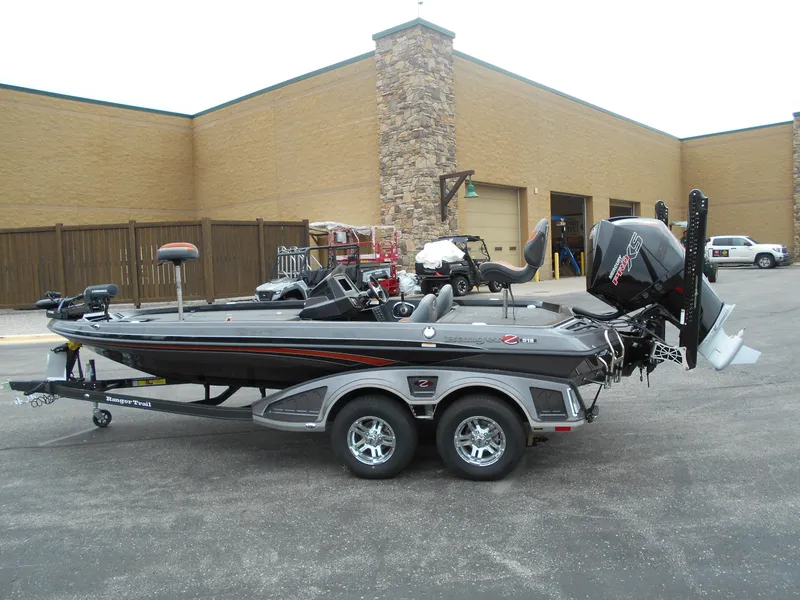 Slide: The Image of 2024 Ranger Z519 Ranger Cup Equipped boat on a trailer in a parking lot. - 2