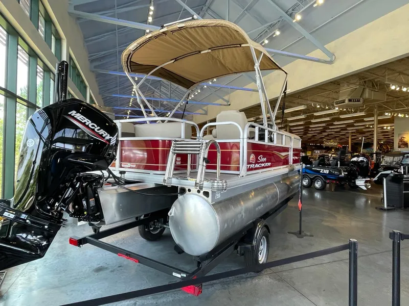 Slide: The Image of 2024 Sun Tracker Party Barge 18 DLX pontoon boat on display in showroom. - 3