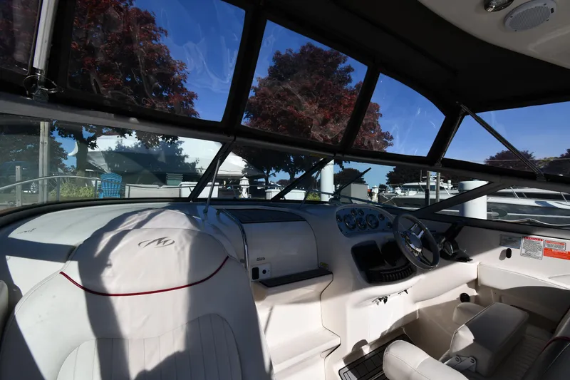 Slide: The Image of 2006 Monterey 298SC Super Sport boat anchor compartment with open hatch, docked by water. - 10