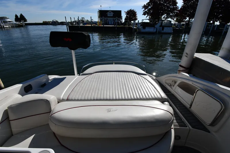 Slide: The Image of 2006 Monterey 298SC Super Sport boat interior at marina, featuring white seating and sleek design. - 27