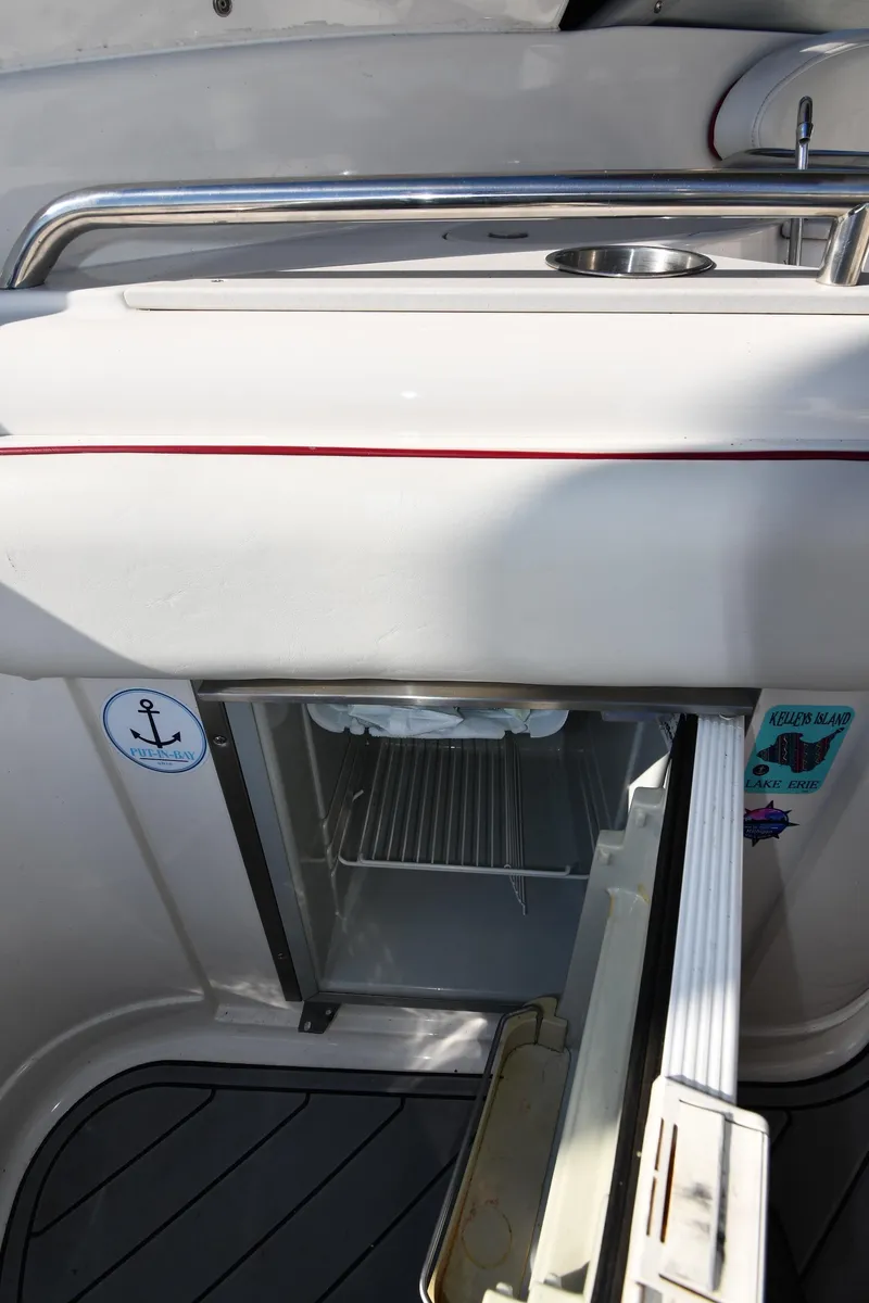 Slide: The Image of 2006 Monterey 298SC Super Sport boat interior with white seating, docked at marina. - 30