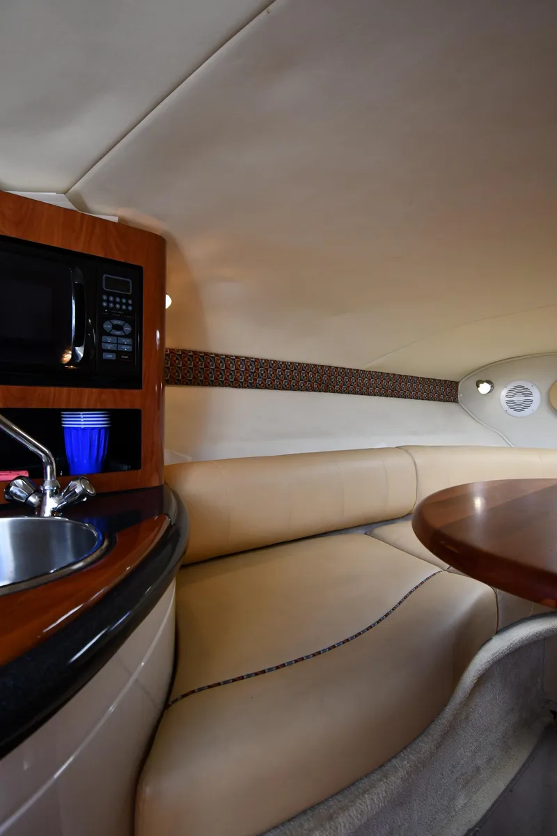 Slide: The Image of 2006 Monterey 298SC Super Sport boat interior with open mini fridge and sink. - 36