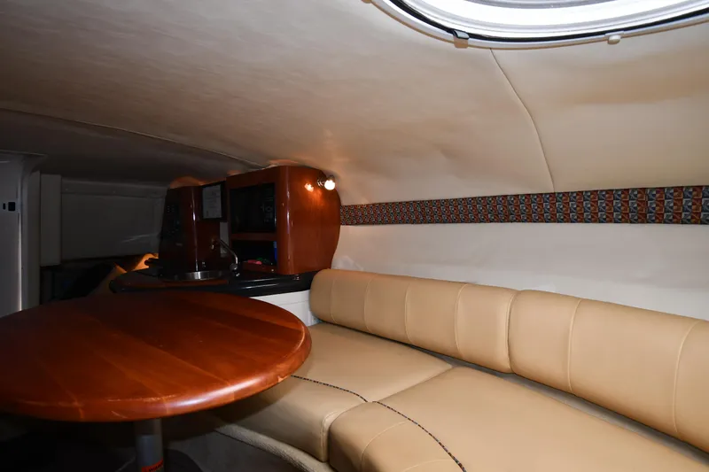 Slide: The Image of 2006 Monterey 298SC Super Sport boat docked at a marina, featuring sleek seating and deck design. - 37