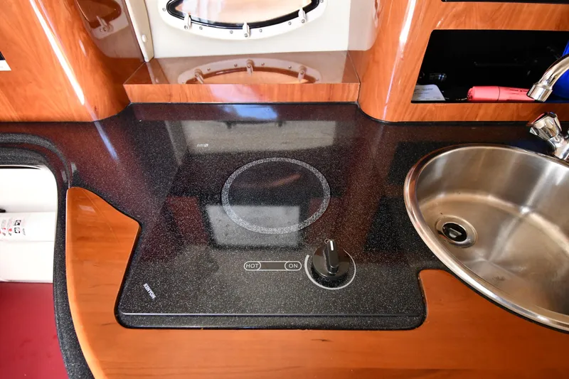 Slide: The Image of 2006 Monterey 298SC Super Sport cabin with beige seating and wooden table. - 40