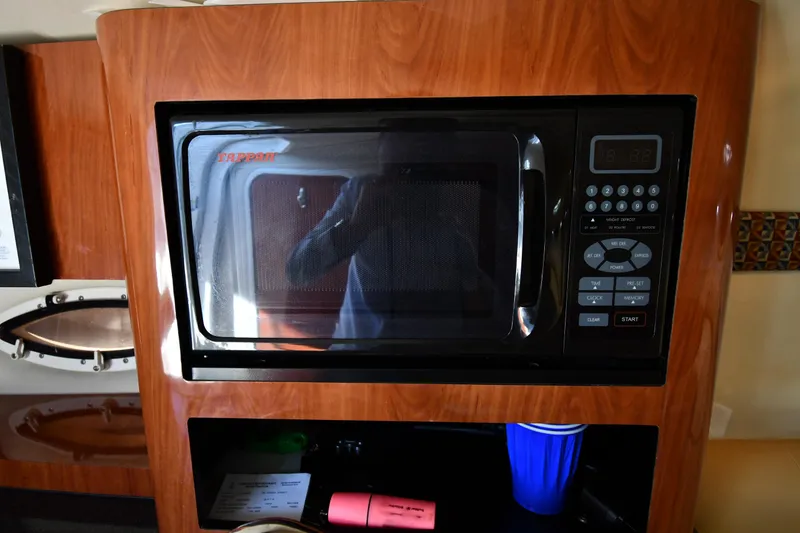 Slide: The Image of Interior of 2006 Monterey 298SC Super Sport boat with beige seating and round table. - 42