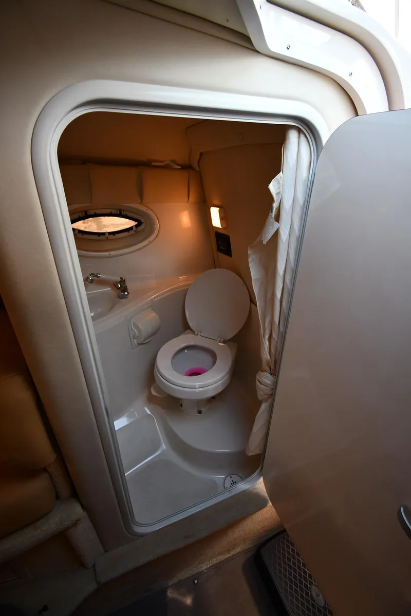 Slide: The Image of Interior of 2006 Monterey 298SC Super Sport with beige seating and wooden table. - 46