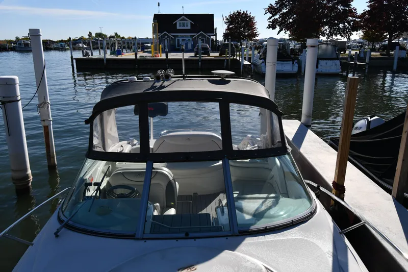 Slide: The Image of 2006 Monterey 298SC Super Sport boat docked under clear blue sky. - 7