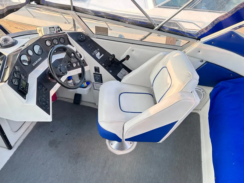 Slide: The Image of 1994 Carver 340 Santego boat helm with steering wheel and captain's chair. - 13
