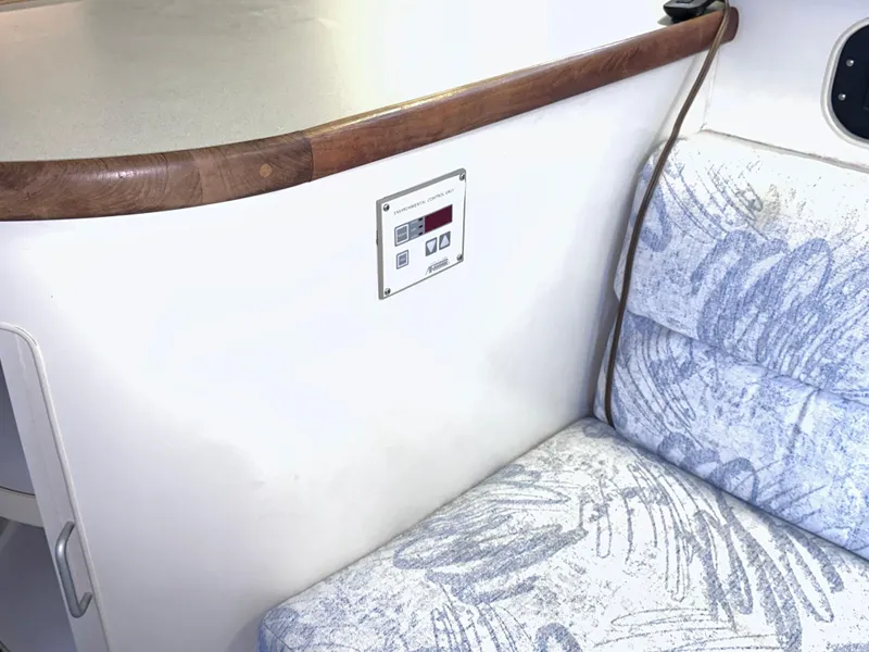 Slide: The Image of Interior of 1994 Carver 340 Santego boat with patterned seating and control panel. - 27