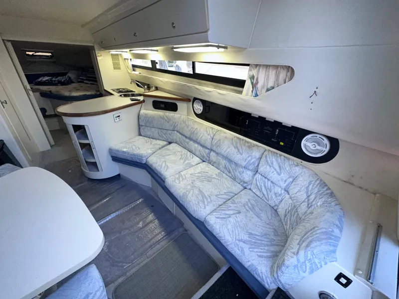Slide: The Image of 1994 Carver 340 Santego interior with curved seating, dining area, and modern amenities. - 33