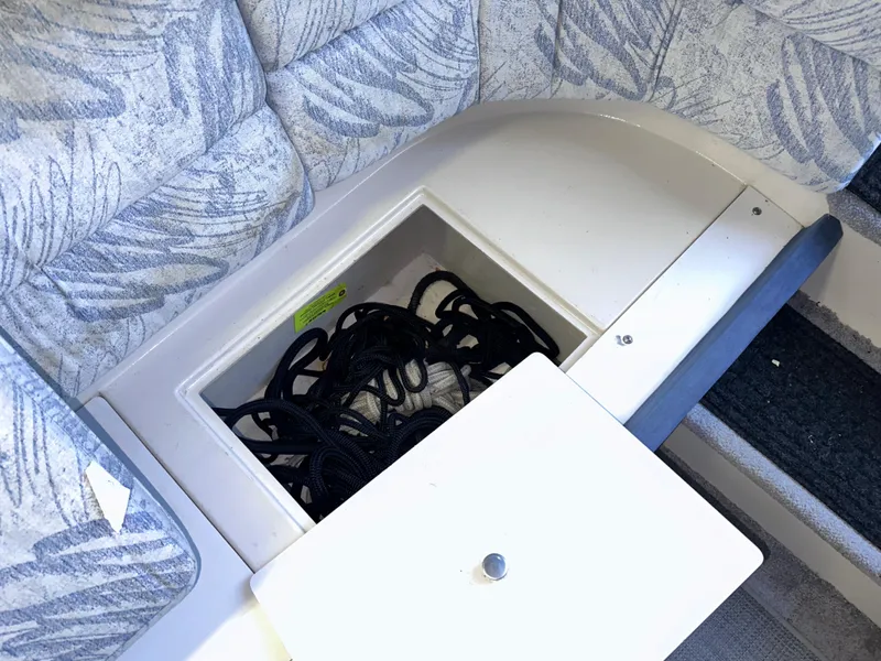 Slide: The Image of Storage compartment with ropes in a 1994 Carver 340 Santego boat interior. - 34