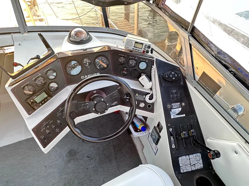 Slide: The Image of 1994 Carver 340 Santego boat helm with steering wheel and control panel. - 6