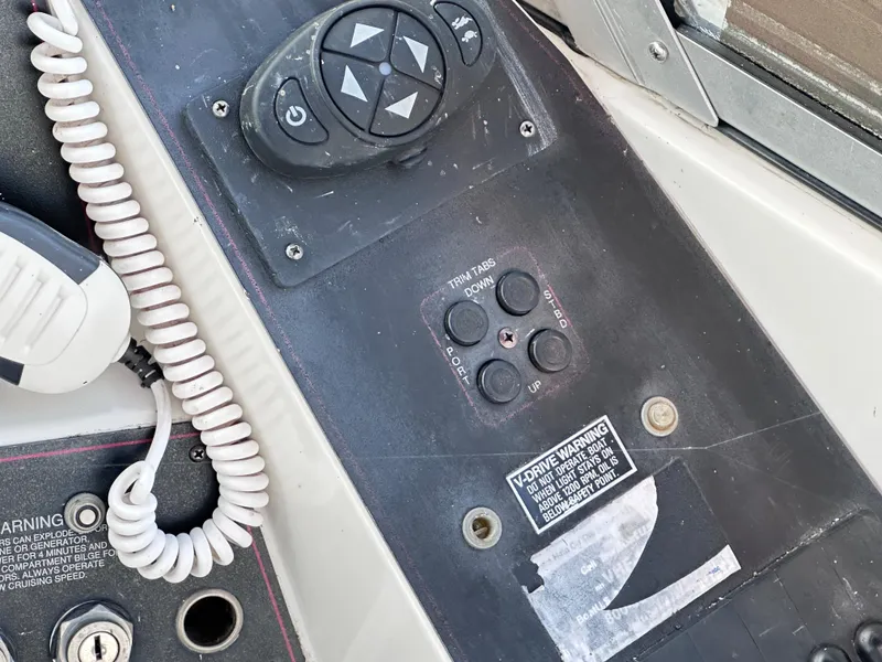 Slide: The Image of Control panel of a 1994 Carver 340 Santego boat with various buttons and a coiled cable. - 10
