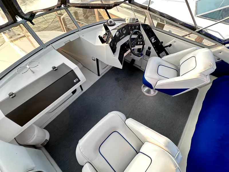 Slide: The Image of 1994 Carver 340 Santego boat interior with helm and seating area. - 12