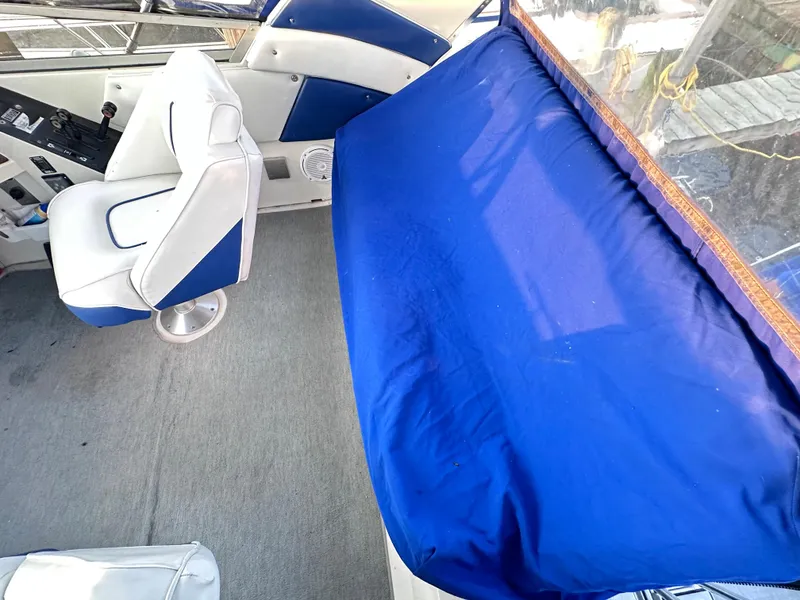 Slide: The Image of 1994 Carver 340 Santego interior with blue and white seating and cover. - 15