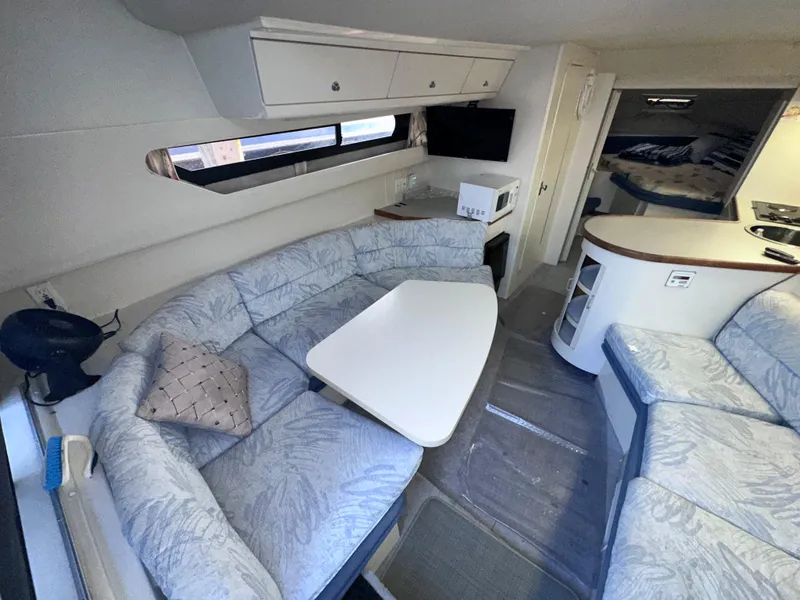 Slide: The Image of 1994 Carver 340 Santego yacht interior with cozy seating, table, and modern amenities. - 32