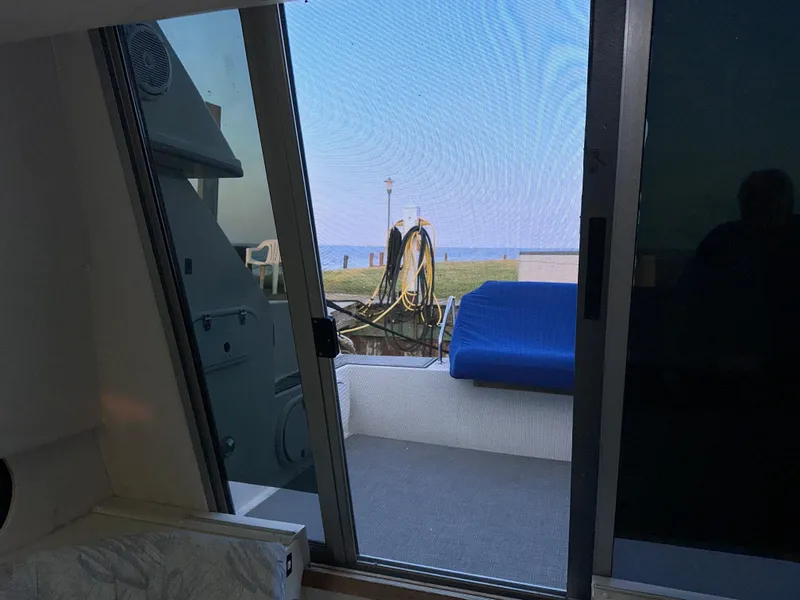 Slide: The Image of Interior view from a 1994 Carver 340 Santego yacht, showing a marina and blue sky. - 35