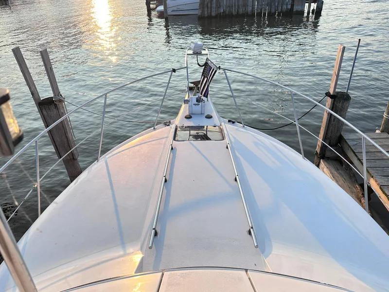 Slide: The Image of 1994 Carver 340 Santego yacht docked at sunset, viewed from the bow. - 4