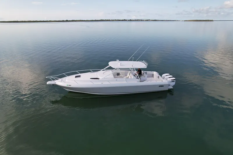 Slide: The Image of 2001 Intrepid 377 Walkaround boat on calm water, side view. - 11