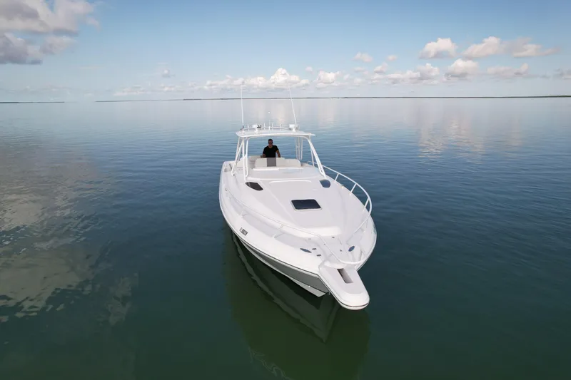 Slide: The Image of 2001 Intrepid 377 Walkaround boat on calm water under a clear sky. - 12