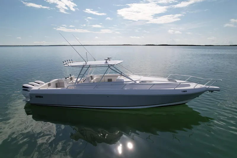 Slide: The Image of 2001 Intrepid 377 Walkaround boat on calm water under a clear sky. - 13