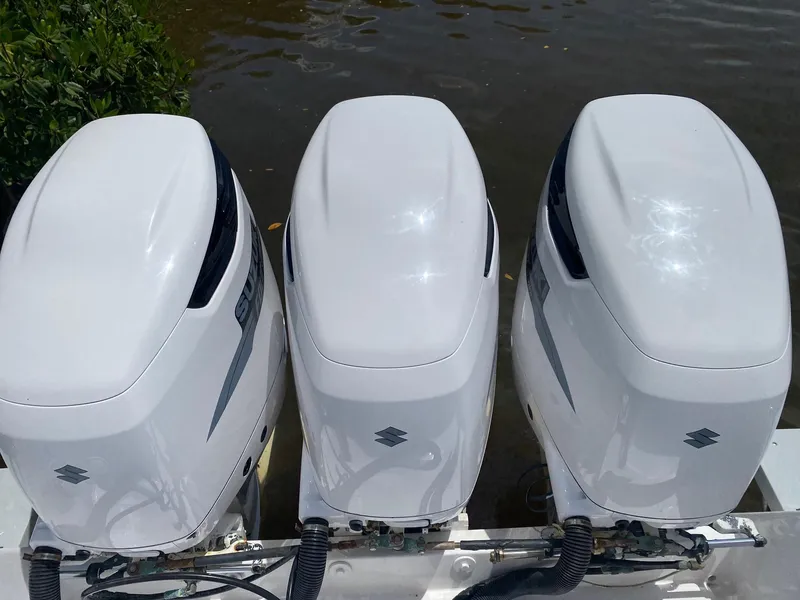 Slide: The Image of Three white outboard motors on a 2001 Intrepid 377 Walkaround boat. - 22
