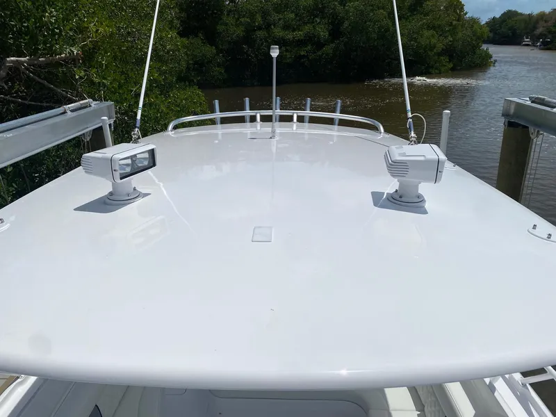 Slide: The Image of 2001 Intrepid 377 Walkaround boat deck with river and greenery background. - 25