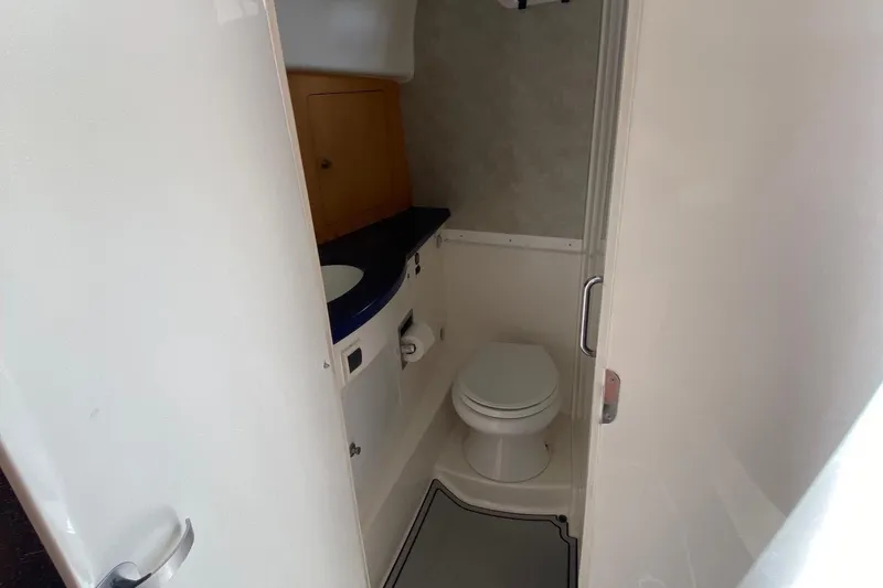 Slide: The Image of 2001 Intrepid 377 Walkaround boat bathroom interior with toilet and sink. - 28