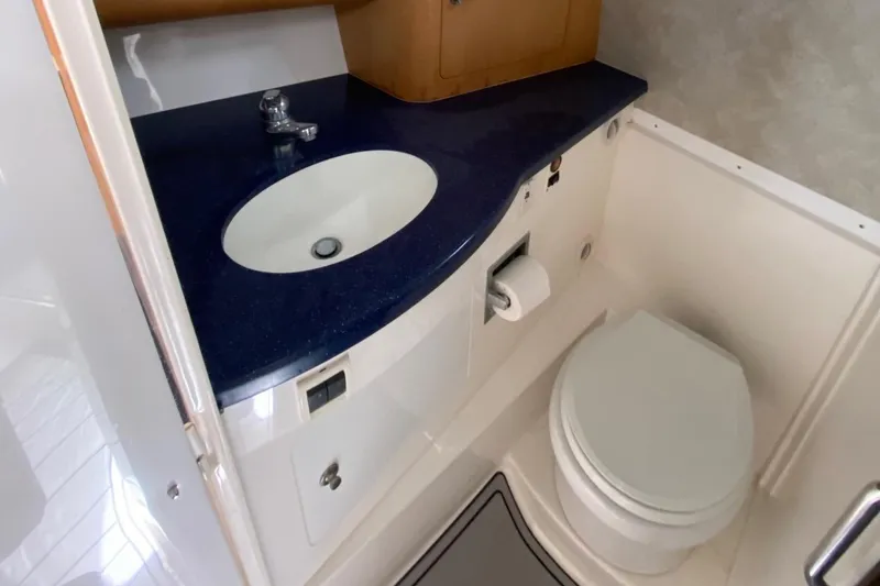 Slide: The Image of 2001 Intrepid 377 Walkaround bathroom with blue countertop and white fixtures. - 31