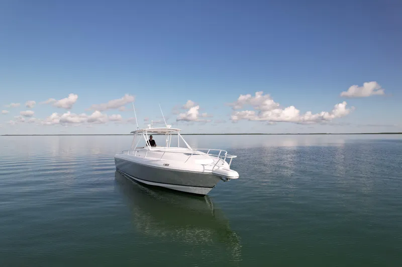 Slide: The Image of 2001 Intrepid 377 Walkaround boat on calm water under a clear sky. - 6