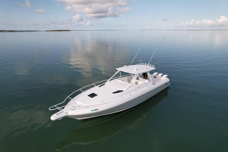 Slide: The Image of 2001 Intrepid 377 Walkaround boat on calm water under a partly cloudy sky. - 7