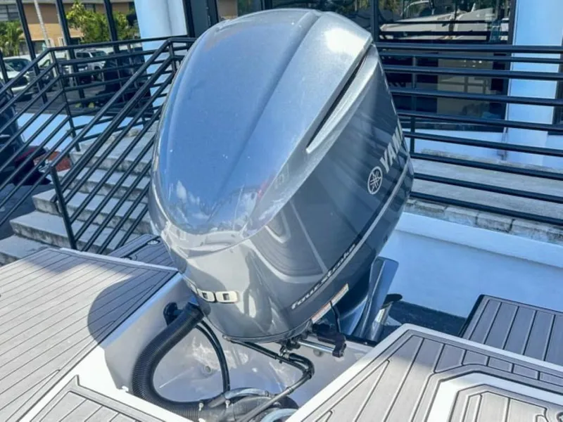 Slide: The Image of 2024 Starcraft SVX 231 OB DH boat with Yamaha outboard motor, docked outdoors. - 12