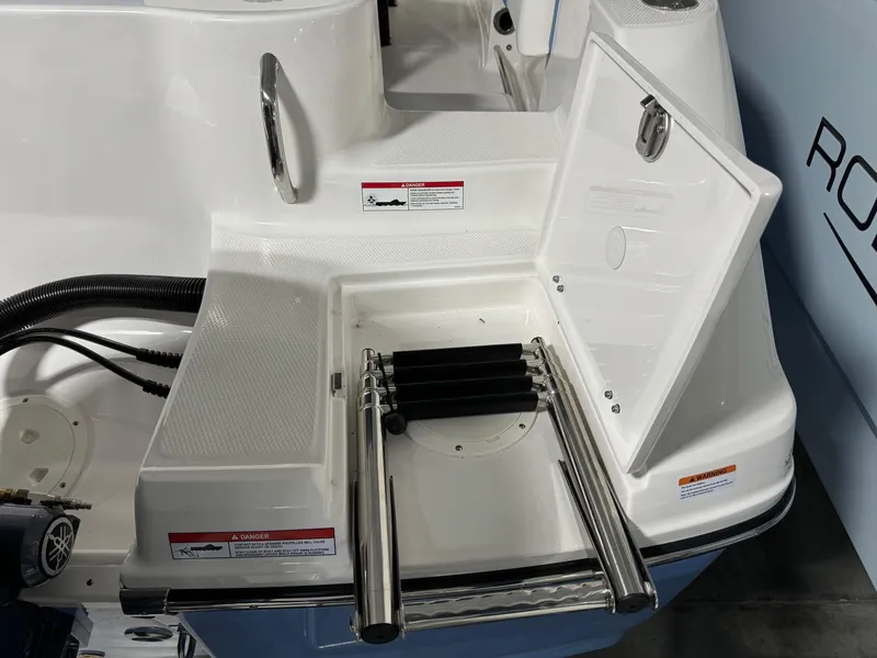 Slide: The Image of 2025 Robalo R202 Explorer boat with open swim ladder compartment. - 5
