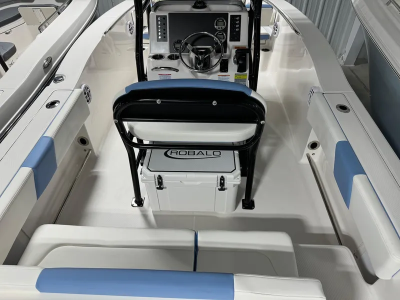 Slide: The Image of 2025 Robalo R202 Explorer boat interior with steering console and seating. - 6