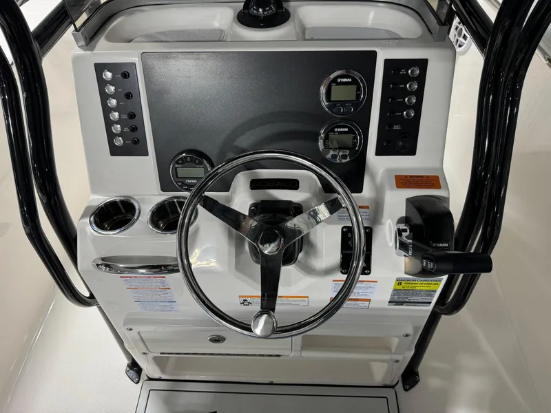 Slide: The Image of 2025 Robalo R202 Explorer boat dashboard with steering wheel and control panel. - 9