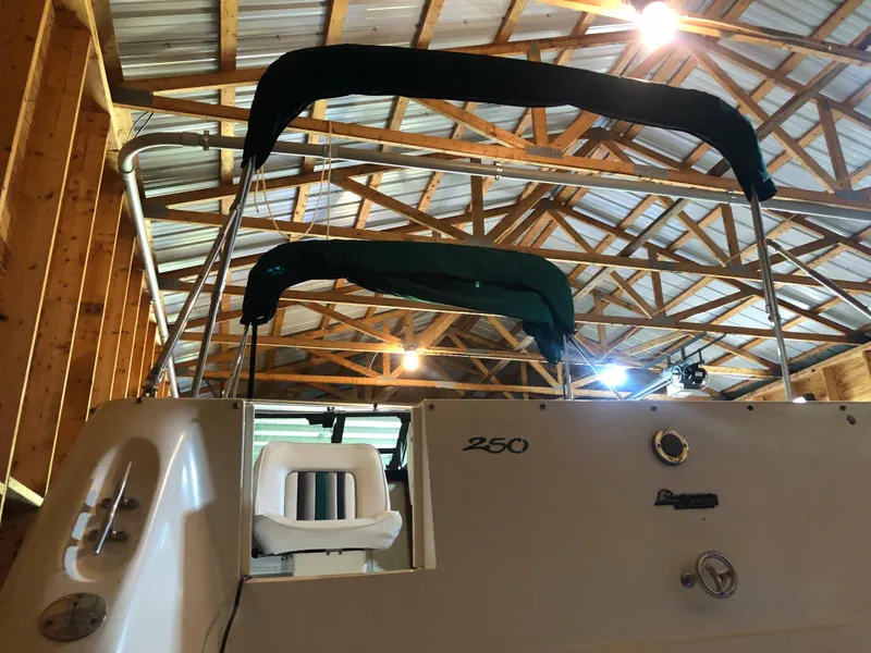 Slide: The Image of 1991 Sea Ray 250 Weekender boat in wooden garage, rear view. - 12