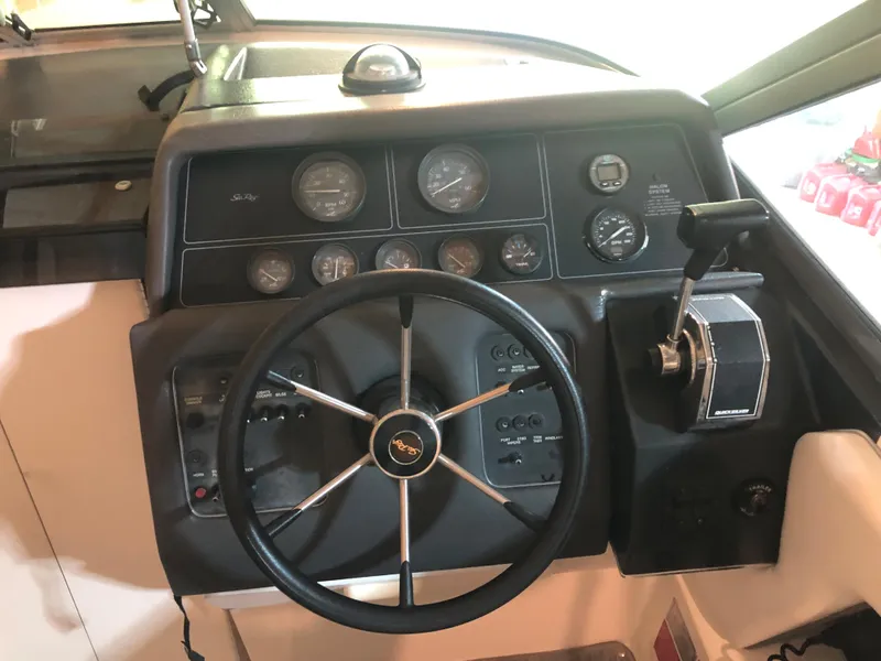 Slide: The Image of 1991 Sea Ray 250 Weekender dashboard with steering wheel and control panel. - 16