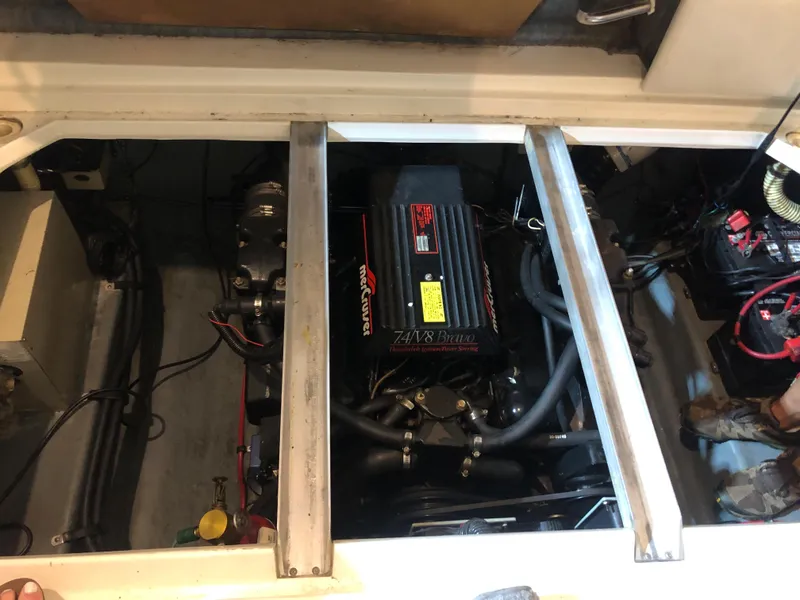 Slide: The Image of Engine compartment of a 1991 Sea Ray 250 Weekender boat, featuring a MerCruiser engine. - 20